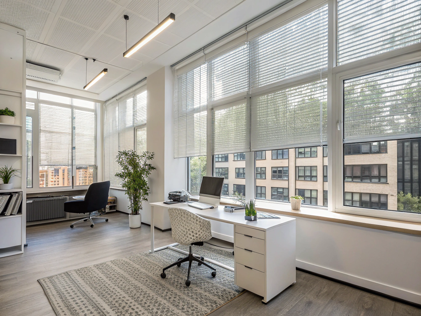 Vertical blinds on floor-to-ceiling office windows.