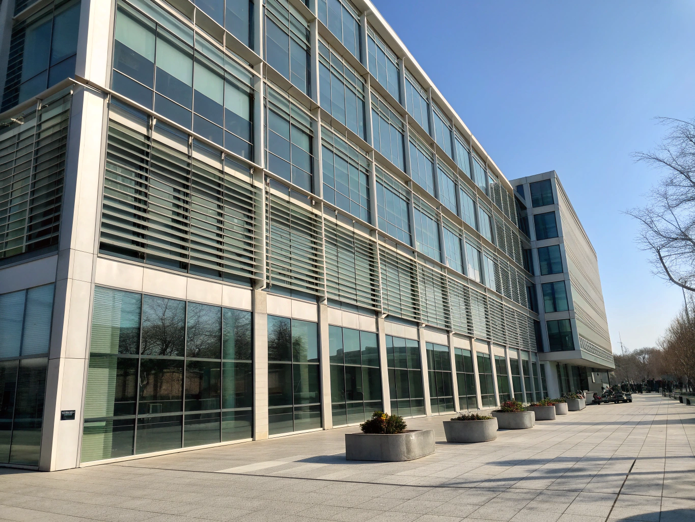 High-rise architectural glass facade fitted with motorized roller shades.